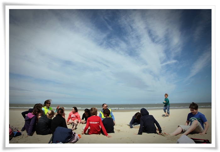 De groep rust uit op het strand